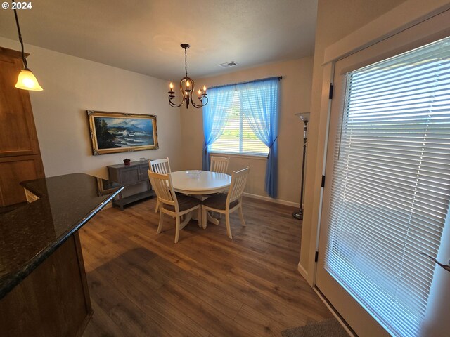 dining room featuring a chandelier and dark hardwood / wood-style floors