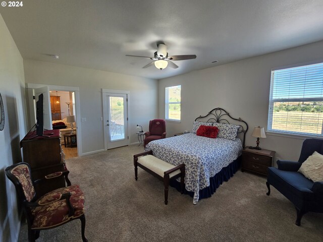 carpeted bedroom with ceiling fan and access to outside