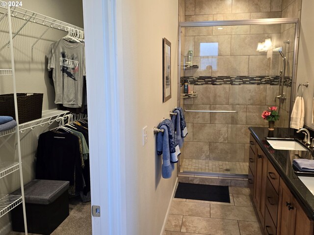 bathroom featuring vanity, tile patterned floors, and an enclosed shower