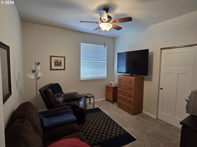 living room featuring ceiling fan and light colored carpet