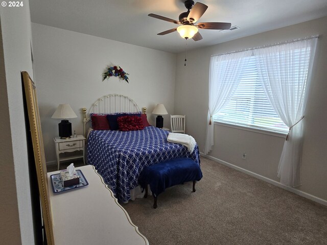 bedroom featuring ceiling fan and carpet