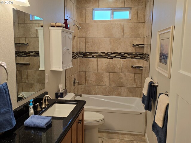 full bathroom featuring tile patterned floors, toilet, vanity, and tiled shower / bath