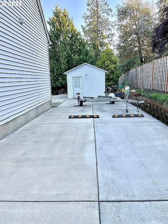 view of patio / terrace featuring a storage shed