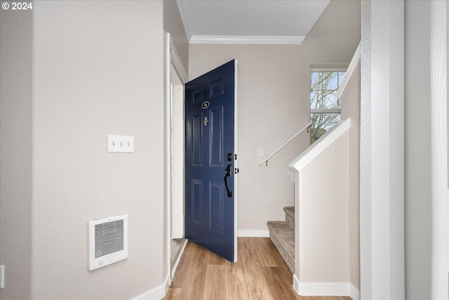 foyer featuring crown molding and light hardwood / wood-style floors