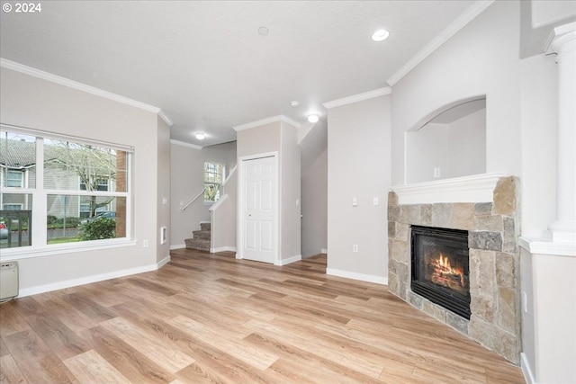 unfurnished living room featuring a fireplace, light hardwood / wood-style floors, and ornamental molding