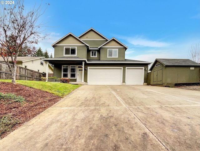 view of front facade with a storage unit, a front yard, and a garage