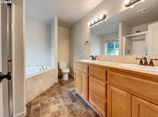 full bathroom featuring toilet, vanity, and separate shower and tub