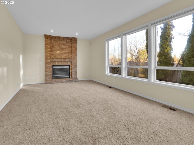 unfurnished living room featuring visible vents, carpet, baseboards, recessed lighting, and a fireplace