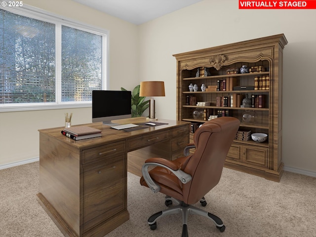 carpeted office space featuring baseboards