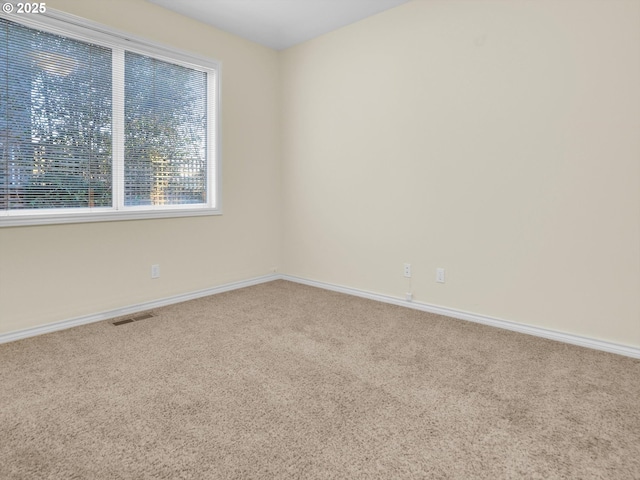 carpeted spare room with visible vents