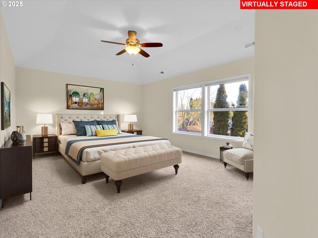 carpeted bedroom with a ceiling fan, baseboards, and visible vents