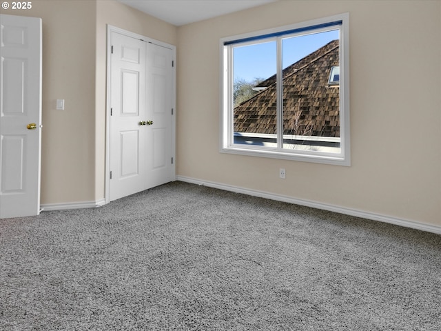 unfurnished bedroom with baseboards and carpet flooring