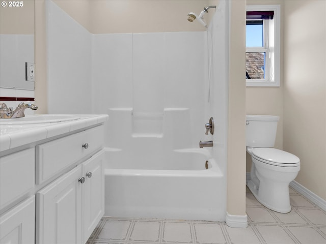 full bathroom featuring vanity, baseboards, bathing tub / shower combination, toilet, and tile patterned floors