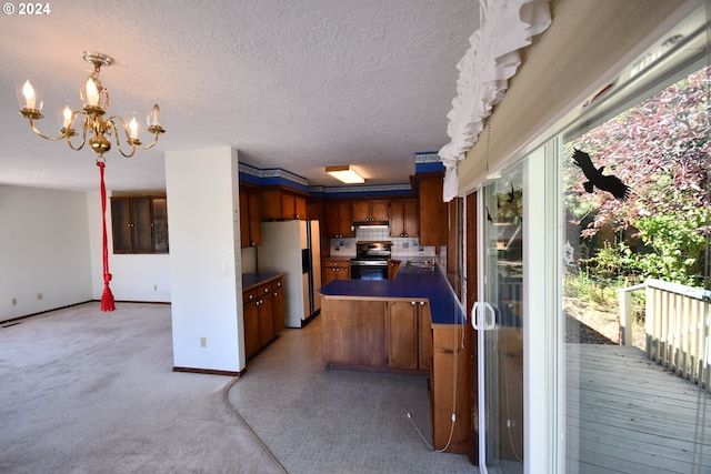 kitchen with sink, stainless steel range with electric cooktop, a notable chandelier, fridge with ice dispenser, and a textured ceiling