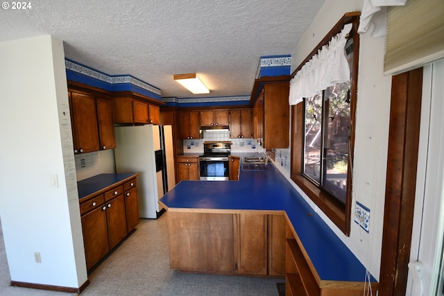 kitchen featuring white refrigerator with ice dispenser, sink, stainless steel electric stove, and tasteful backsplash