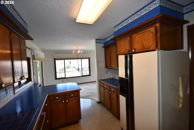 kitchen with an inviting chandelier, tasteful backsplash, white refrigerator with ice dispenser, kitchen peninsula, and a textured ceiling