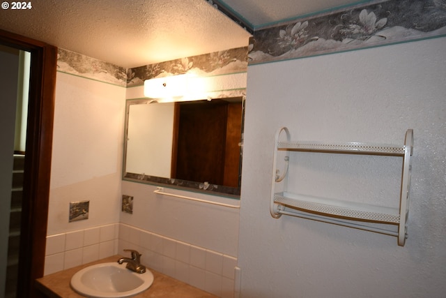 bathroom featuring vanity and a textured ceiling