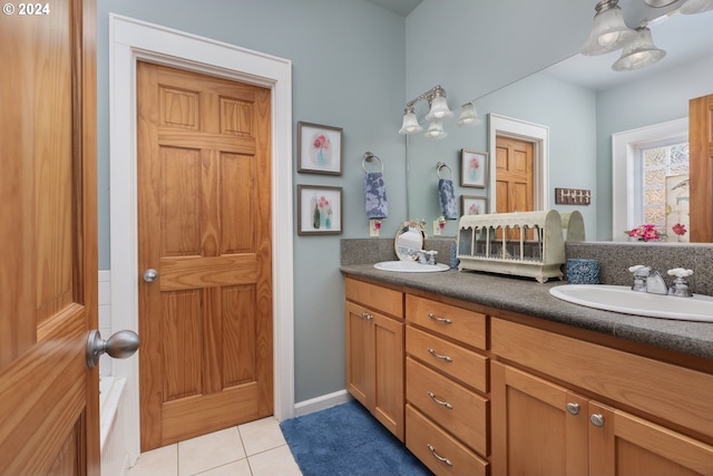 bathroom featuring double vanity, tile patterned flooring, and a sink