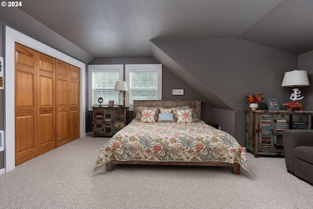 carpeted bedroom featuring lofted ceiling and a closet