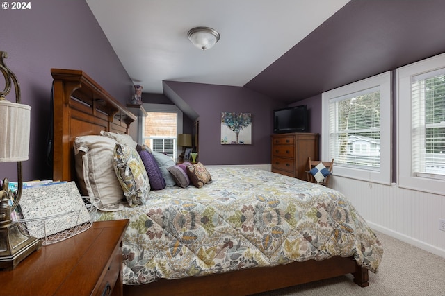 bedroom with carpet floors and lofted ceiling