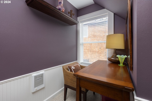 office area featuring lofted ceiling, wainscoting, and heating unit