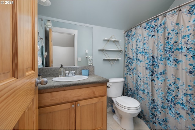 bathroom with curtained shower, vanity, toilet, and tile patterned floors