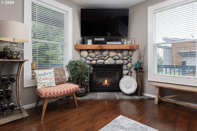 sitting room featuring hardwood / wood-style flooring, a fireplace, and baseboards