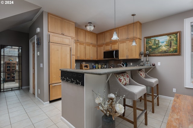 kitchen featuring light tile patterned floors, stainless steel microwave, paneled built in fridge, decorative backsplash, and a peninsula