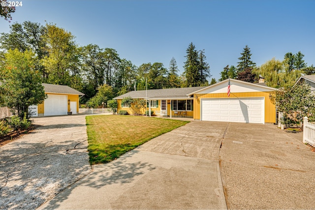 ranch-style house featuring a garage and a front yard