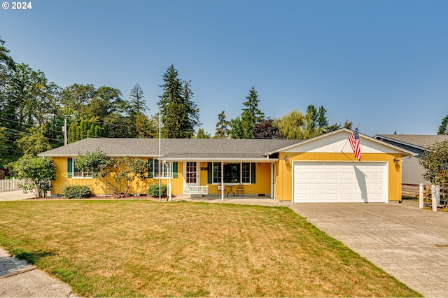 single story home featuring covered porch, a garage, and a front lawn