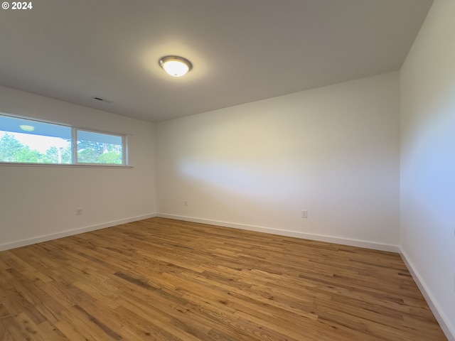 spare room featuring hardwood / wood-style flooring