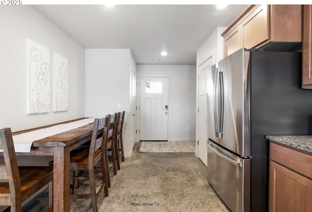 967 NE 11th St, Hermiston, OR 97838 - kitchen featuring freestanding refrigerator, carpet floors, recessed lighting, dark stone counters, and baseboards
