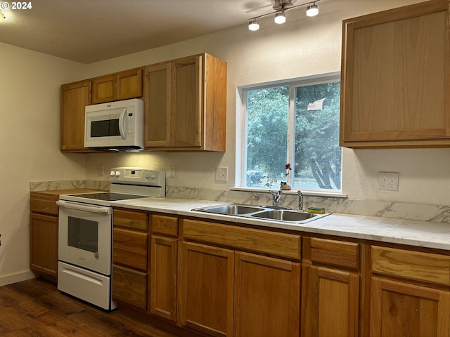 kitchen with white appliances, dark hardwood / wood-style flooring, and sink