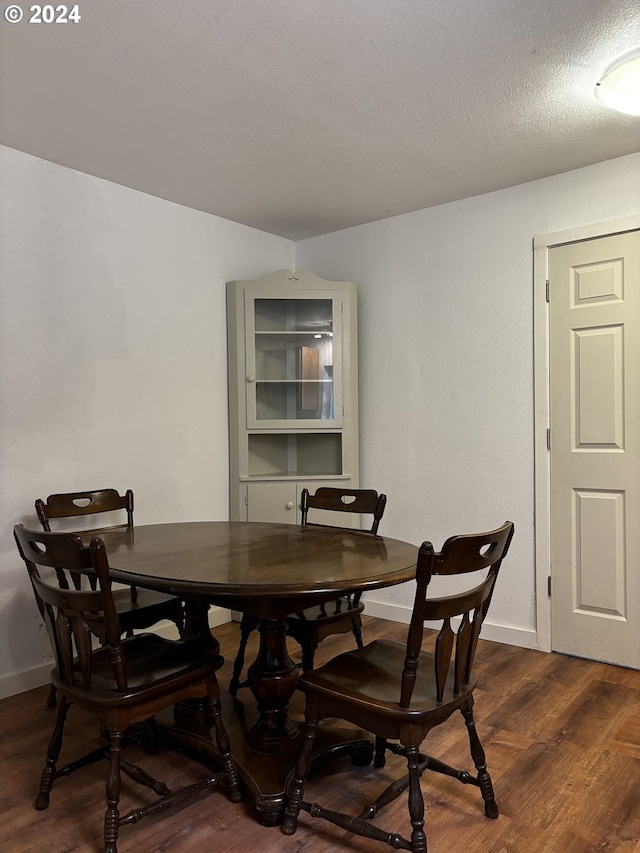 dining space with dark hardwood / wood-style flooring