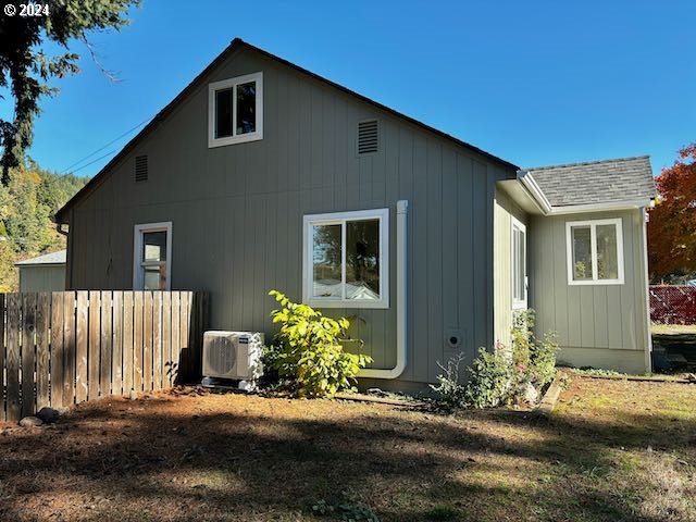 view of side of property with ac unit