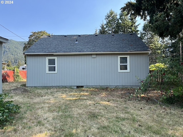 back of house with a lawn