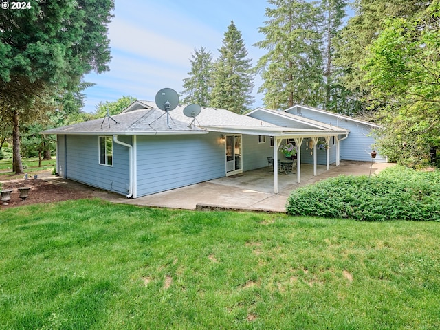 back of house featuring a patio and a yard