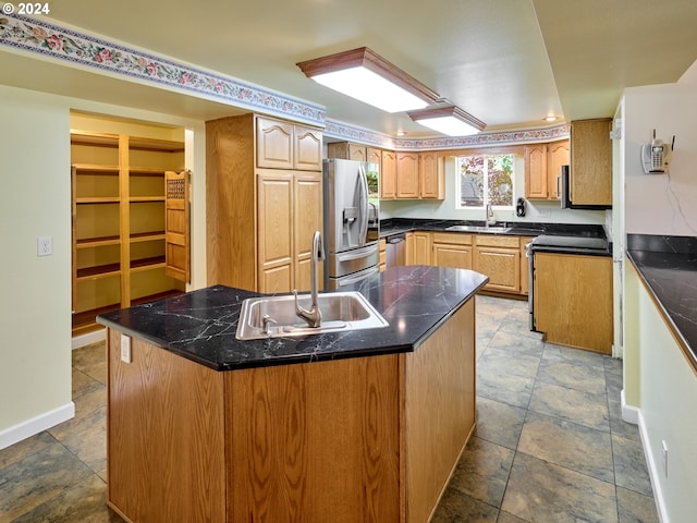 kitchen featuring sink, a kitchen island, and appliances with stainless steel finishes