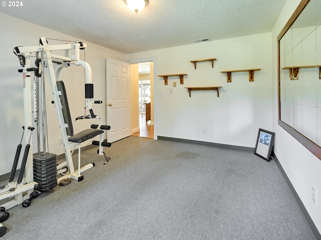 exercise area with a textured ceiling