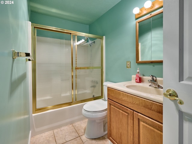 full bathroom with toilet, combined bath / shower with glass door, vanity, and tile patterned floors