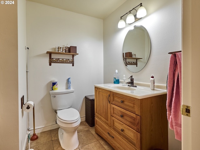 bathroom featuring toilet, vanity, and tile patterned flooring