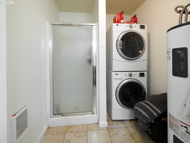 clothes washing area featuring water heater, stacked washer and clothes dryer, and light tile patterned floors