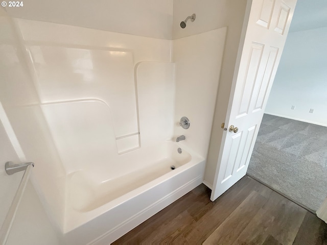 bathroom featuring hardwood / wood-style flooring and shower / tub combination