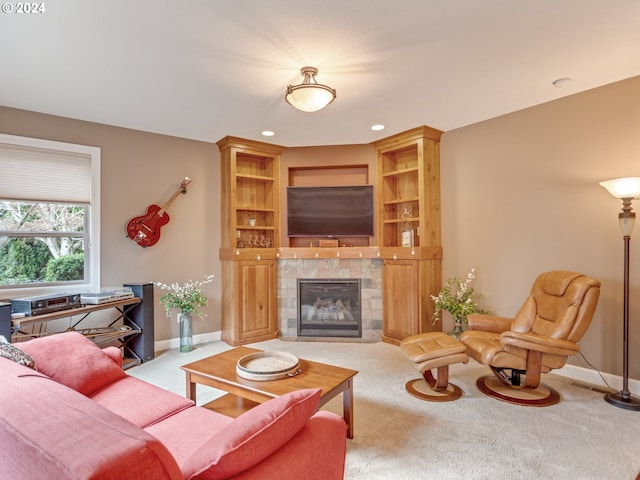 carpeted living room featuring a tile fireplace