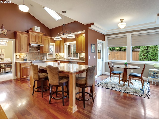 kitchen with a kitchen island, a healthy amount of sunlight, and pendant lighting