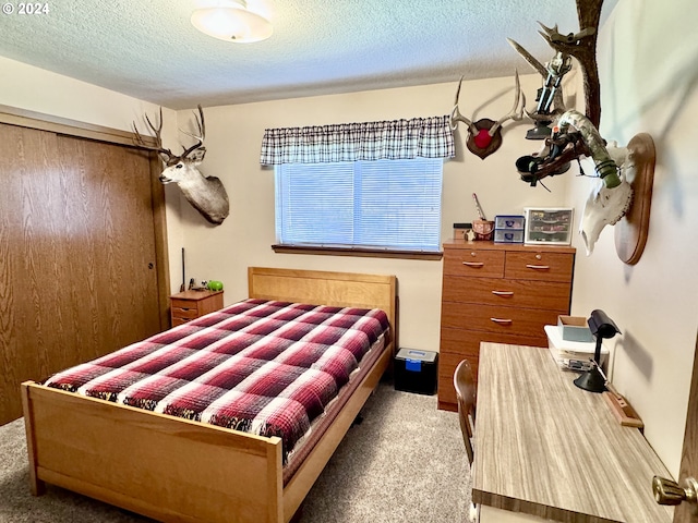 carpeted bedroom featuring a textured ceiling