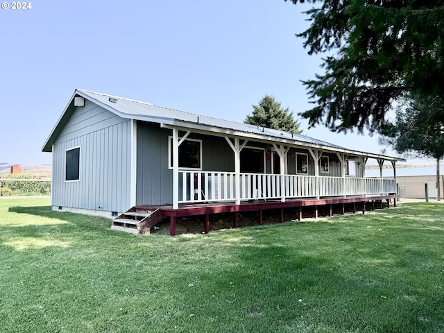 view of front of house with covered porch, metal roof, crawl space, and a front yard