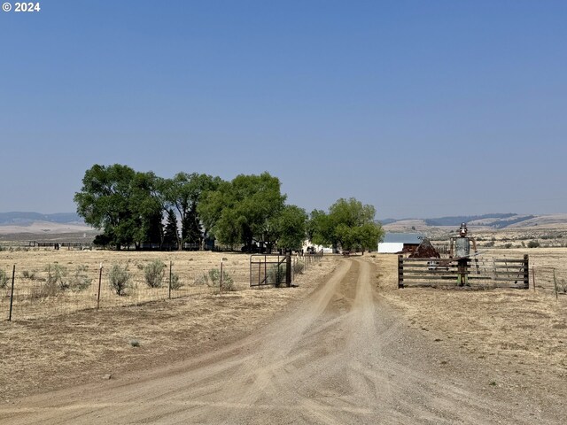 view of street with a rural view and a mountain view