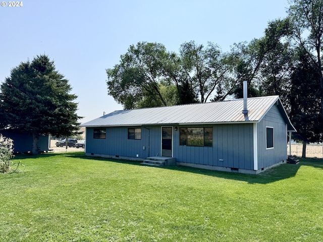 view of front of home with crawl space, metal roof, and a front lawn