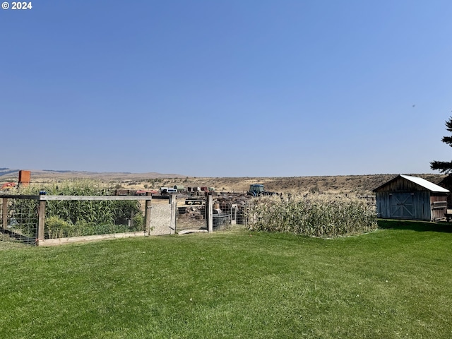 view of yard featuring an outdoor structure and a storage unit